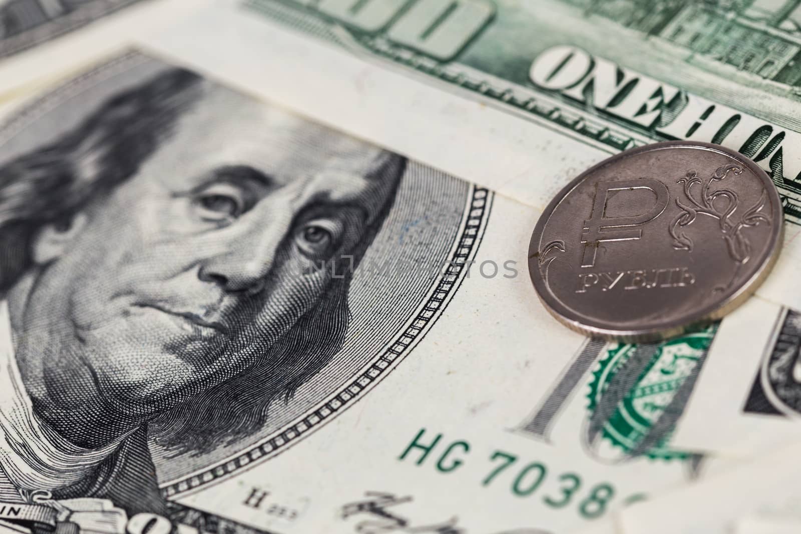 russian rubl coin over us dollar close-up with selective focus and blur