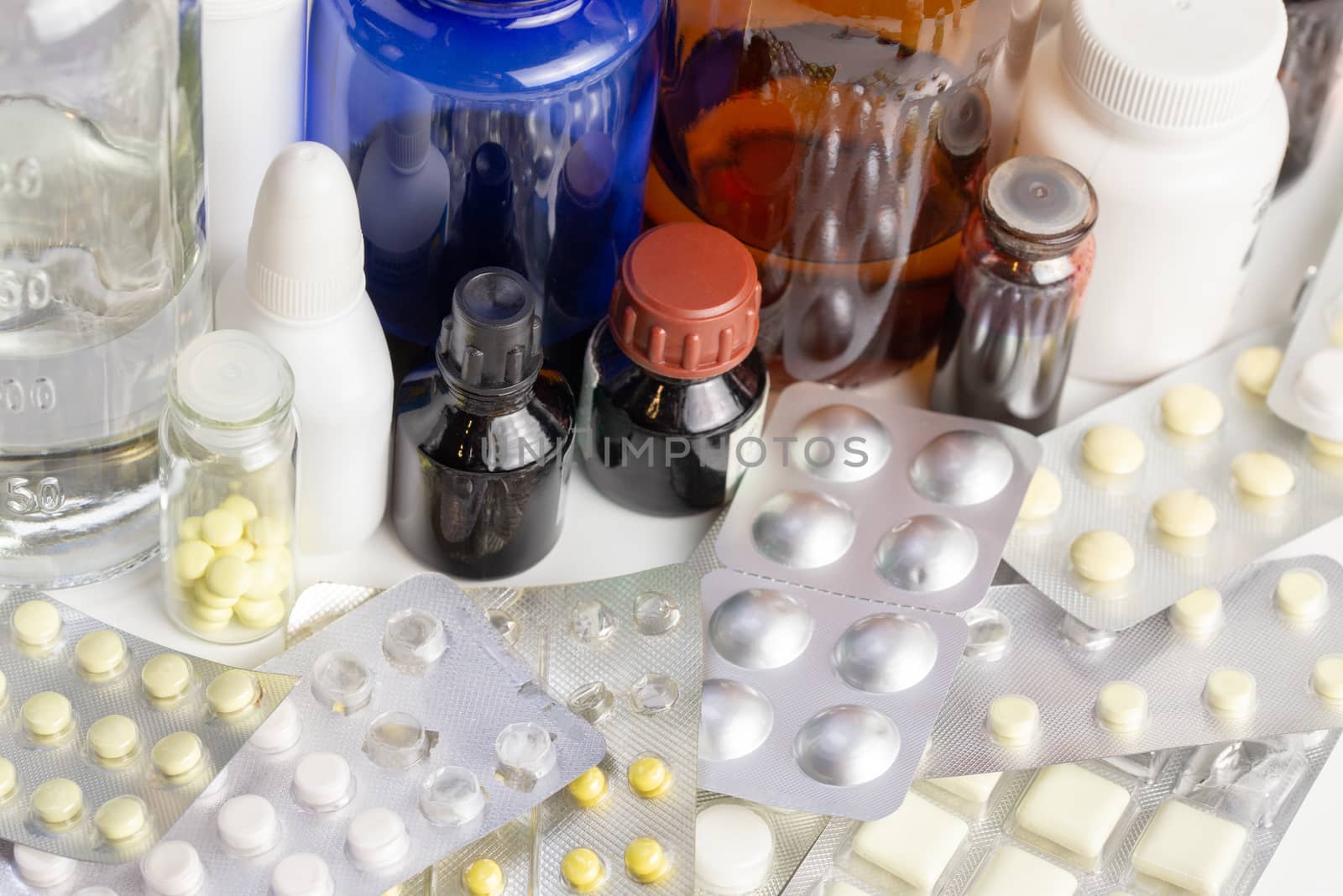 bunch casual of half-used and opened medial bottles and tablets with selective focus.