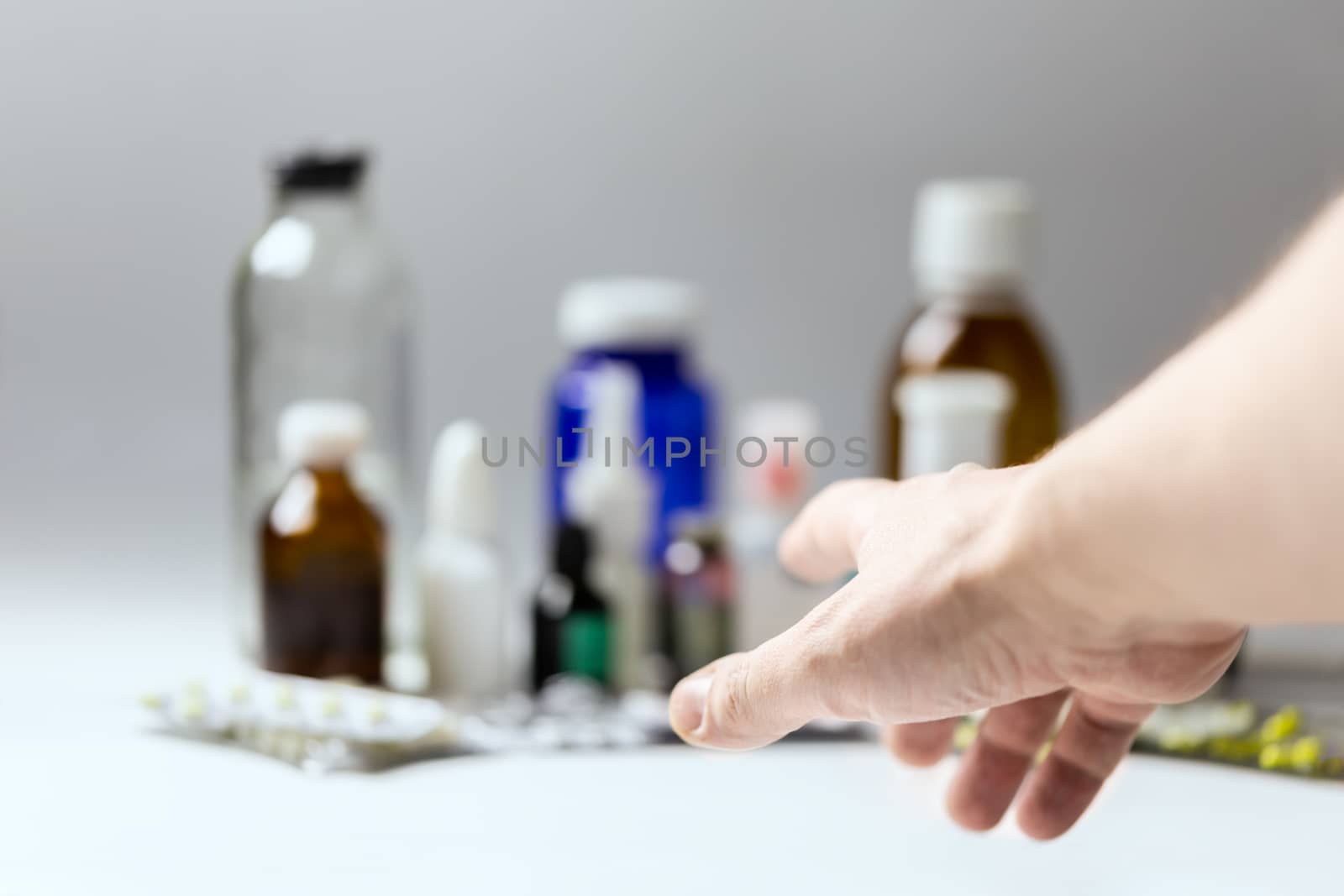 right hand reaching for meds with selective focus and shallow depth of field.