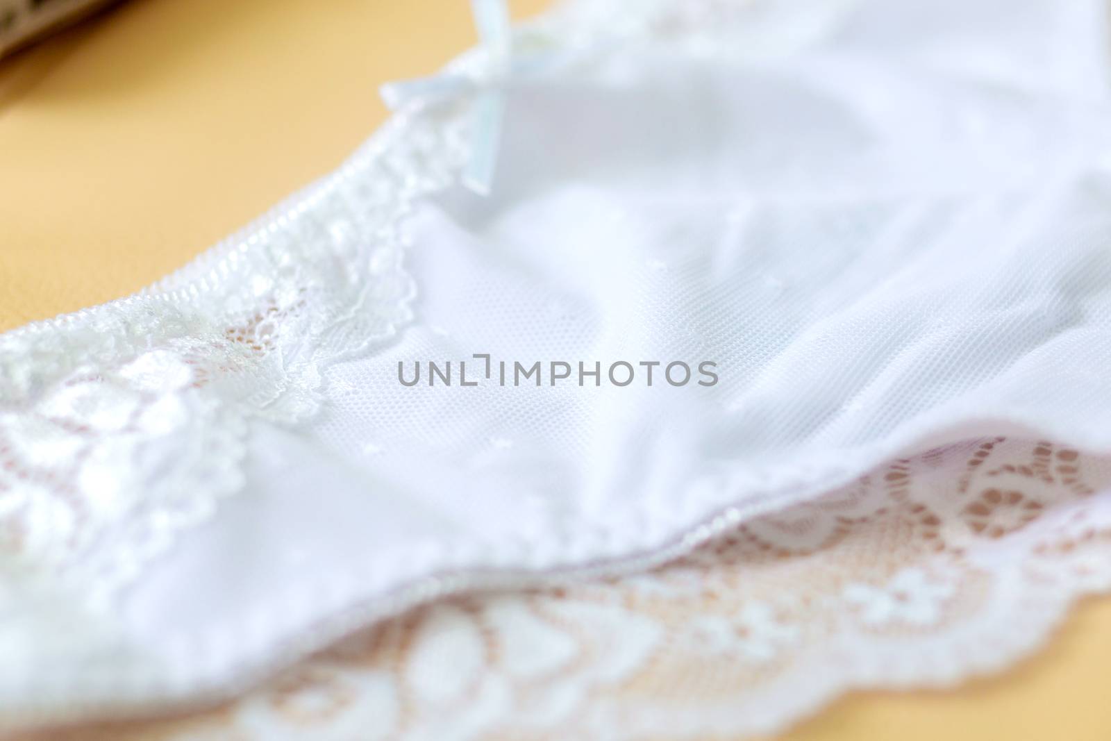 Lace on white womens bikini panties close-up. Soft texture of the fabric of women's underwear