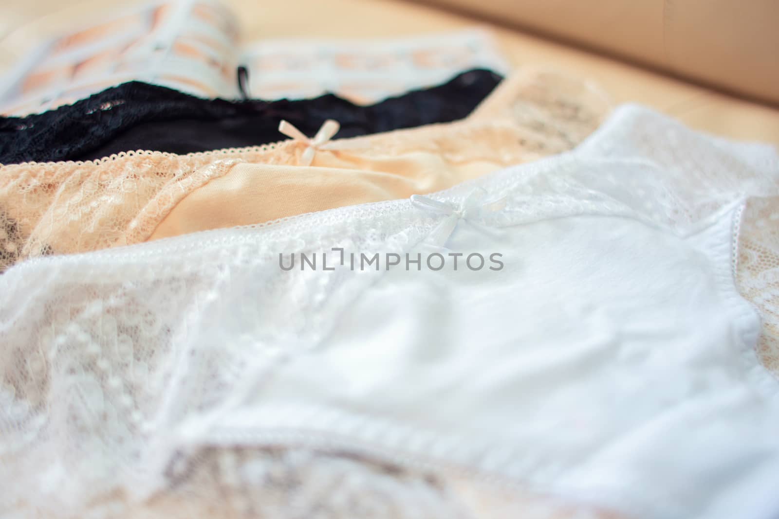 Lace on white womens bikini panties close-up. Soft texture of the fabric of women's underwear