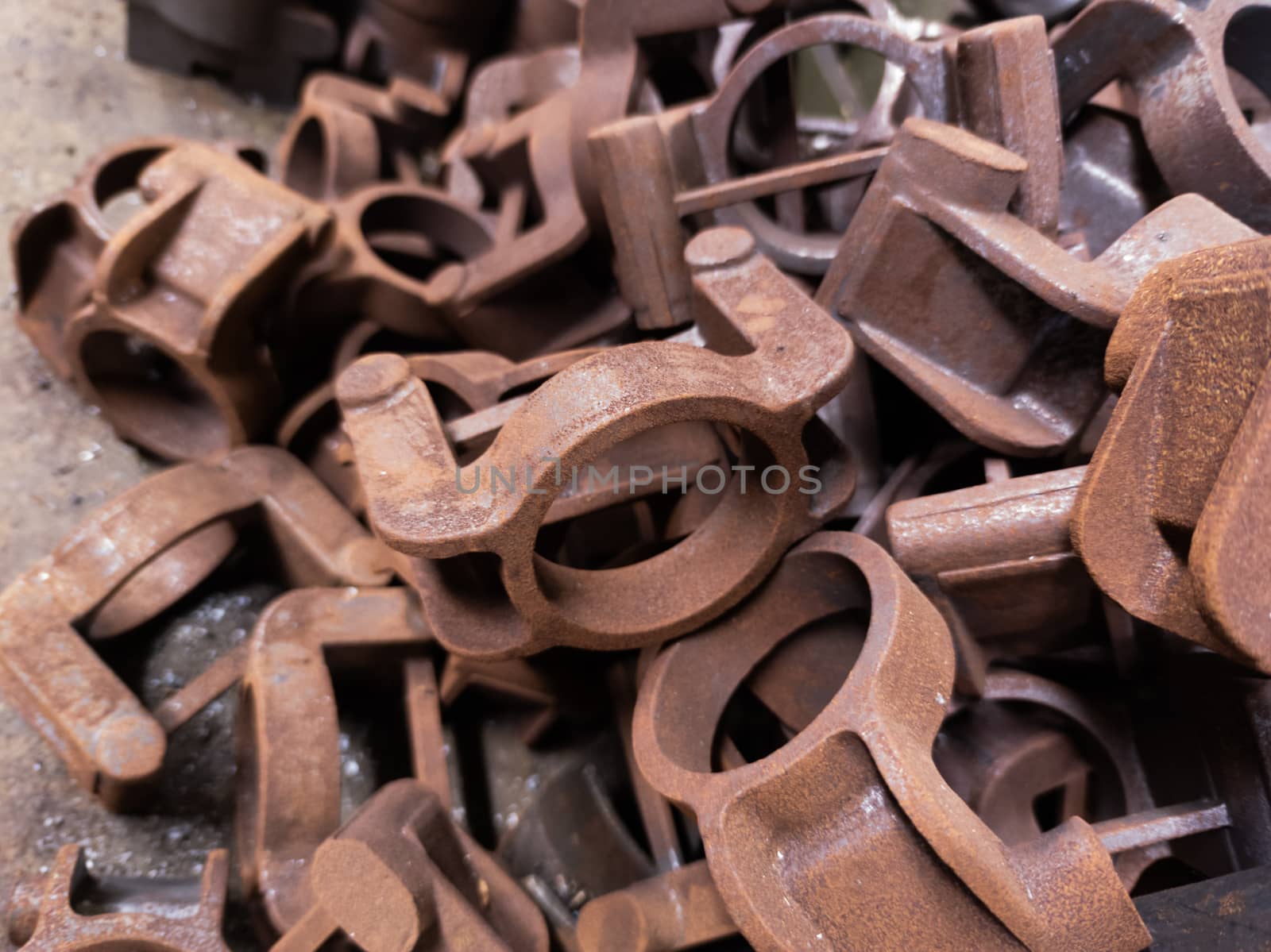rusted metal parts close-up background with selective focus. improper factory storage issue