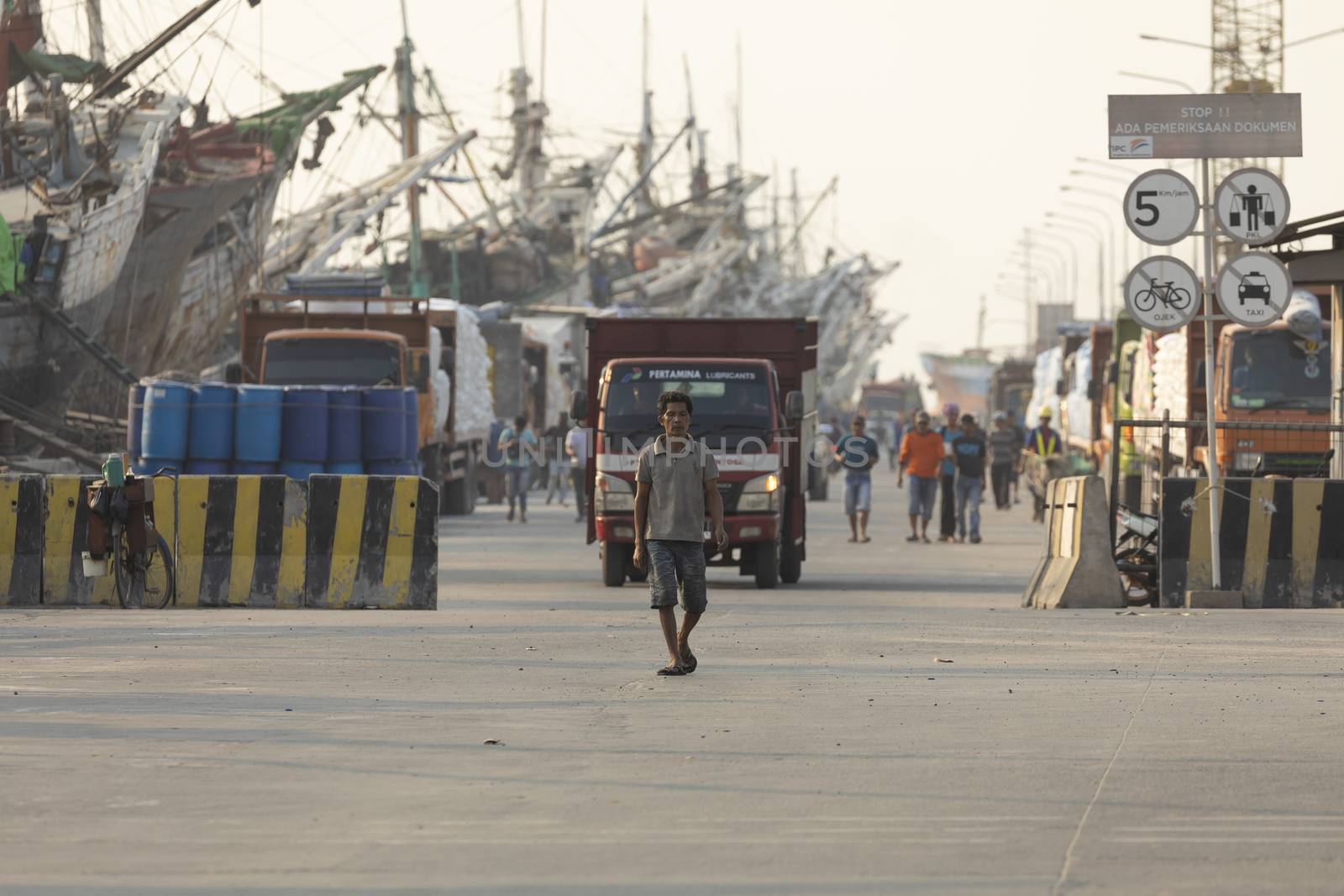 Jakarta, Sunda Kelapa Port, Indonesia - July 15, 2019: Boats, goods and workers in the port of the city of Jakarta, on the shores of Jakarta Bay.