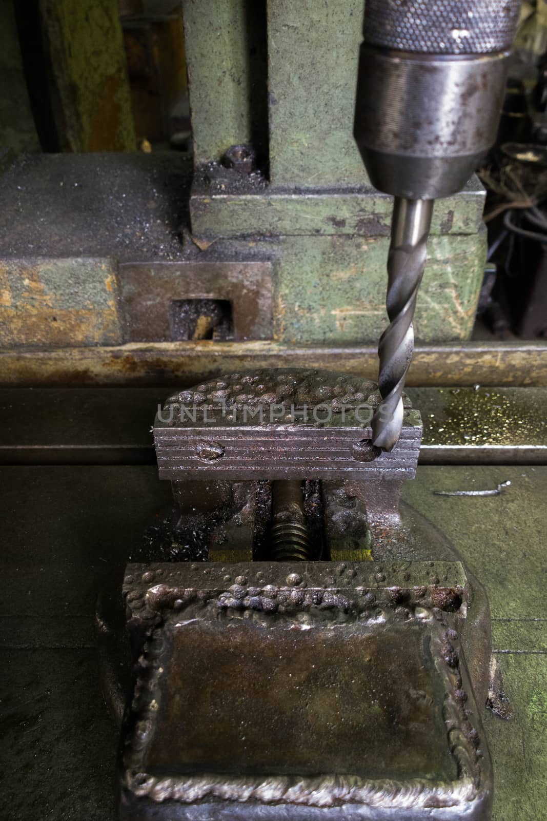 old drilling machine with obsolete used vice with selective focus.