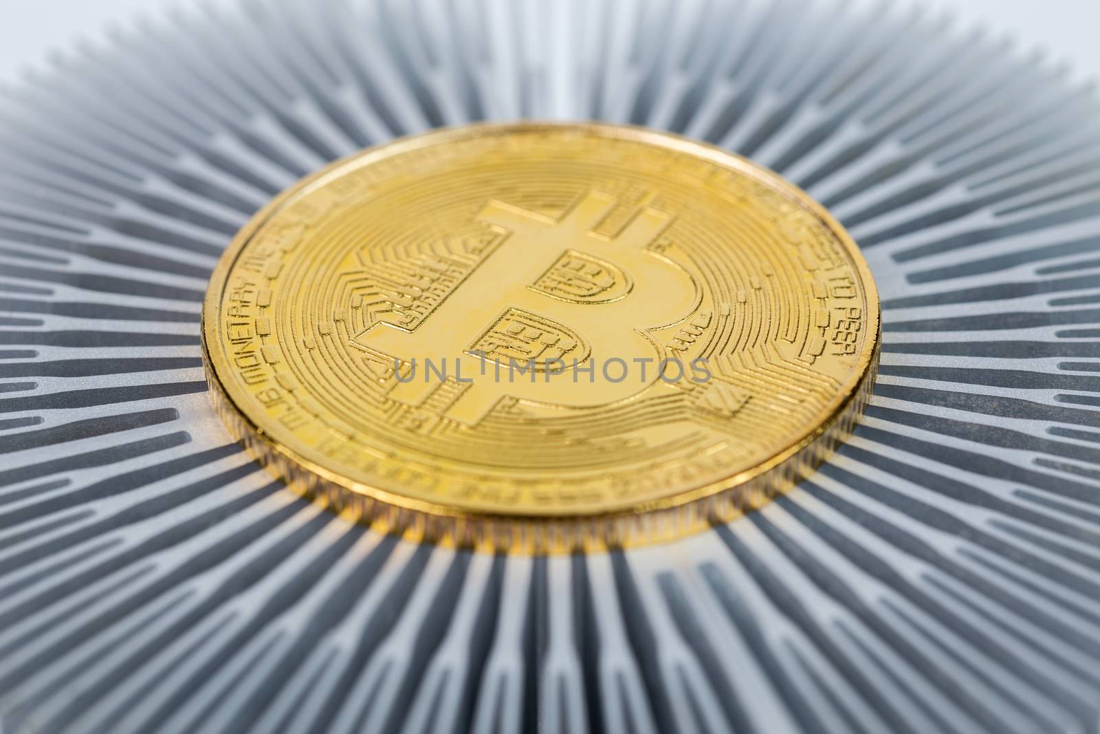 physical bitcoin symbol close-up on aluminium heatsink with selective focus