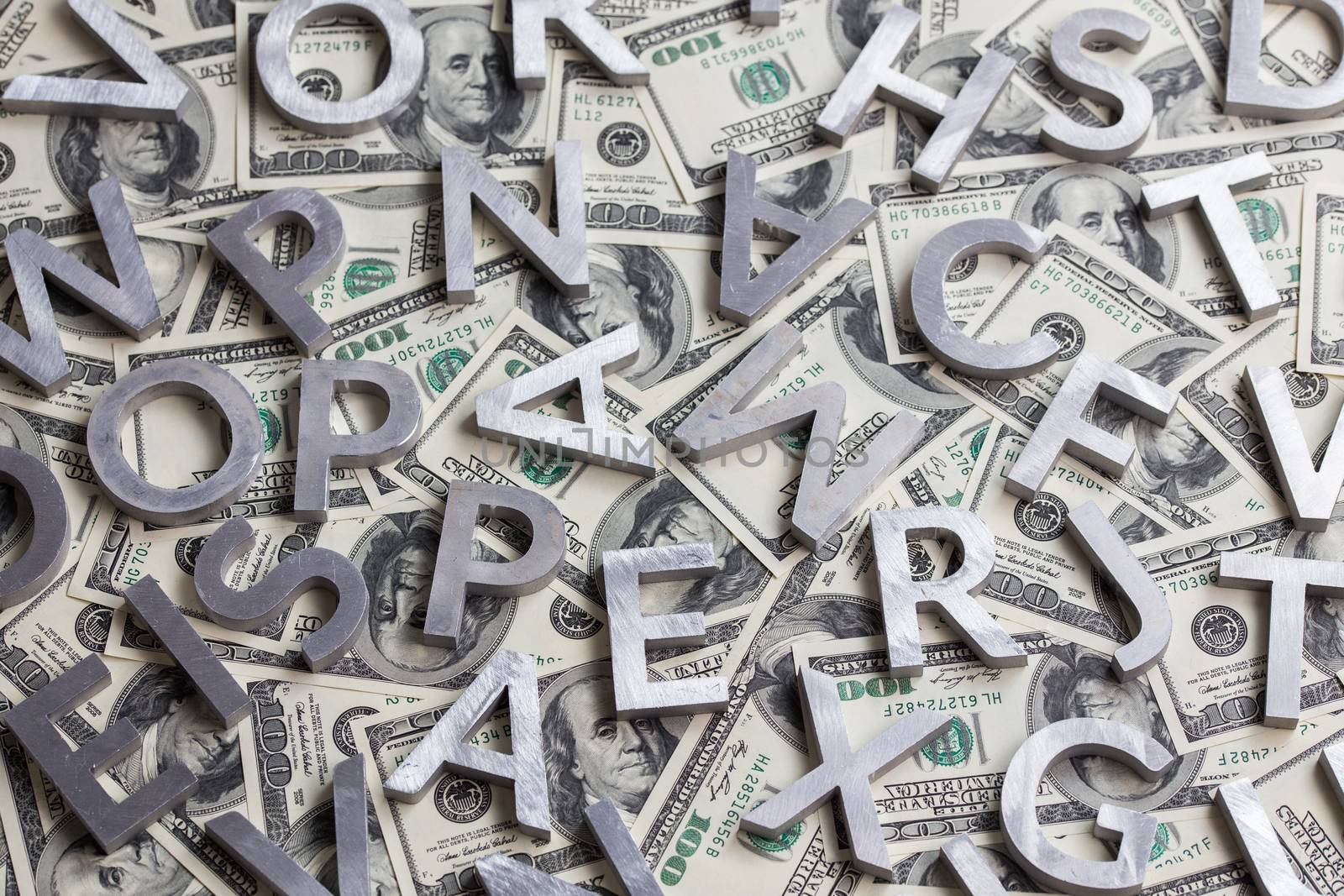 a random metal letters on us dollar background.