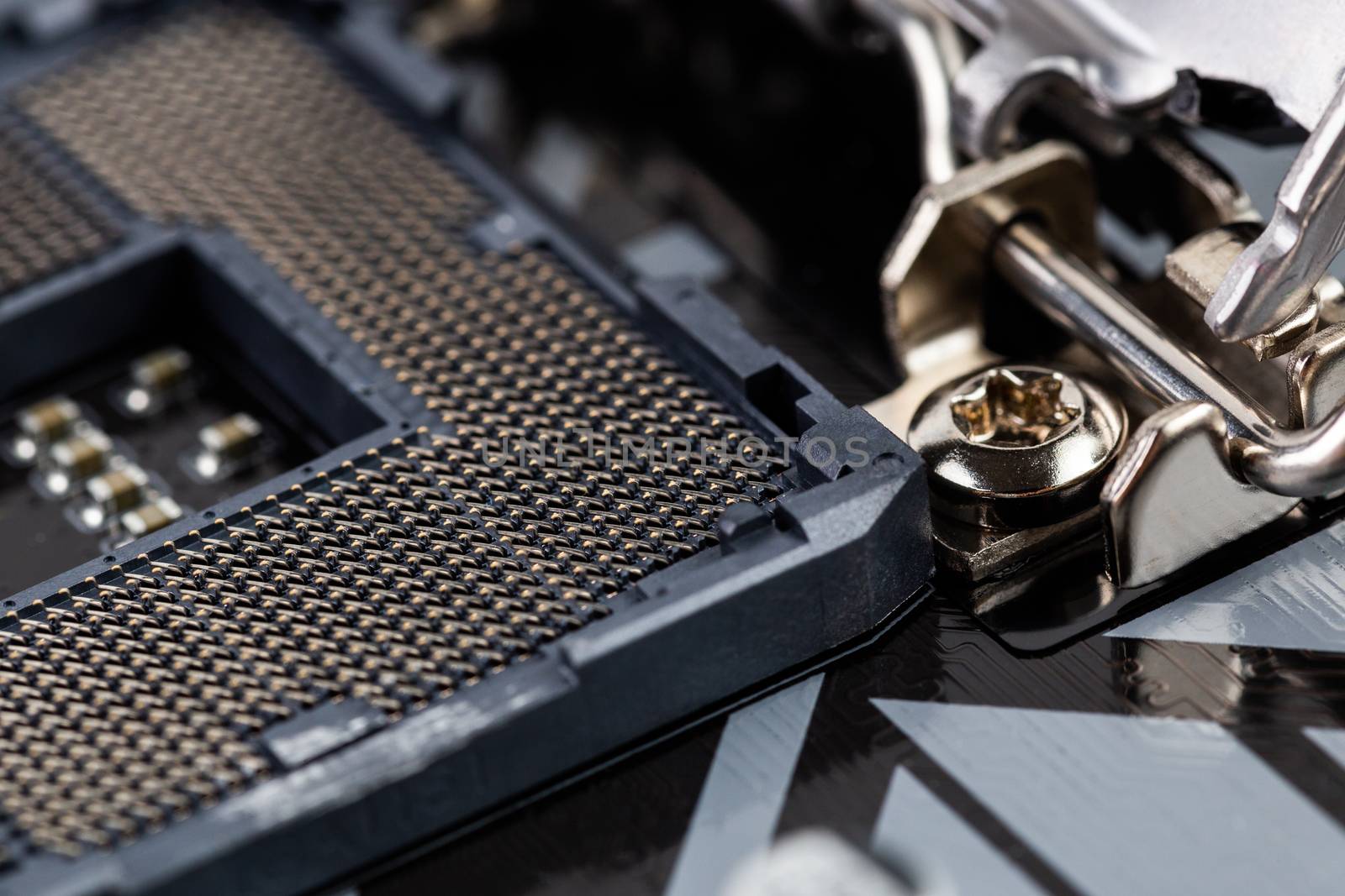 opened central processor land grid array slot on pc mainboard - closeup shot with selective focus and blur
