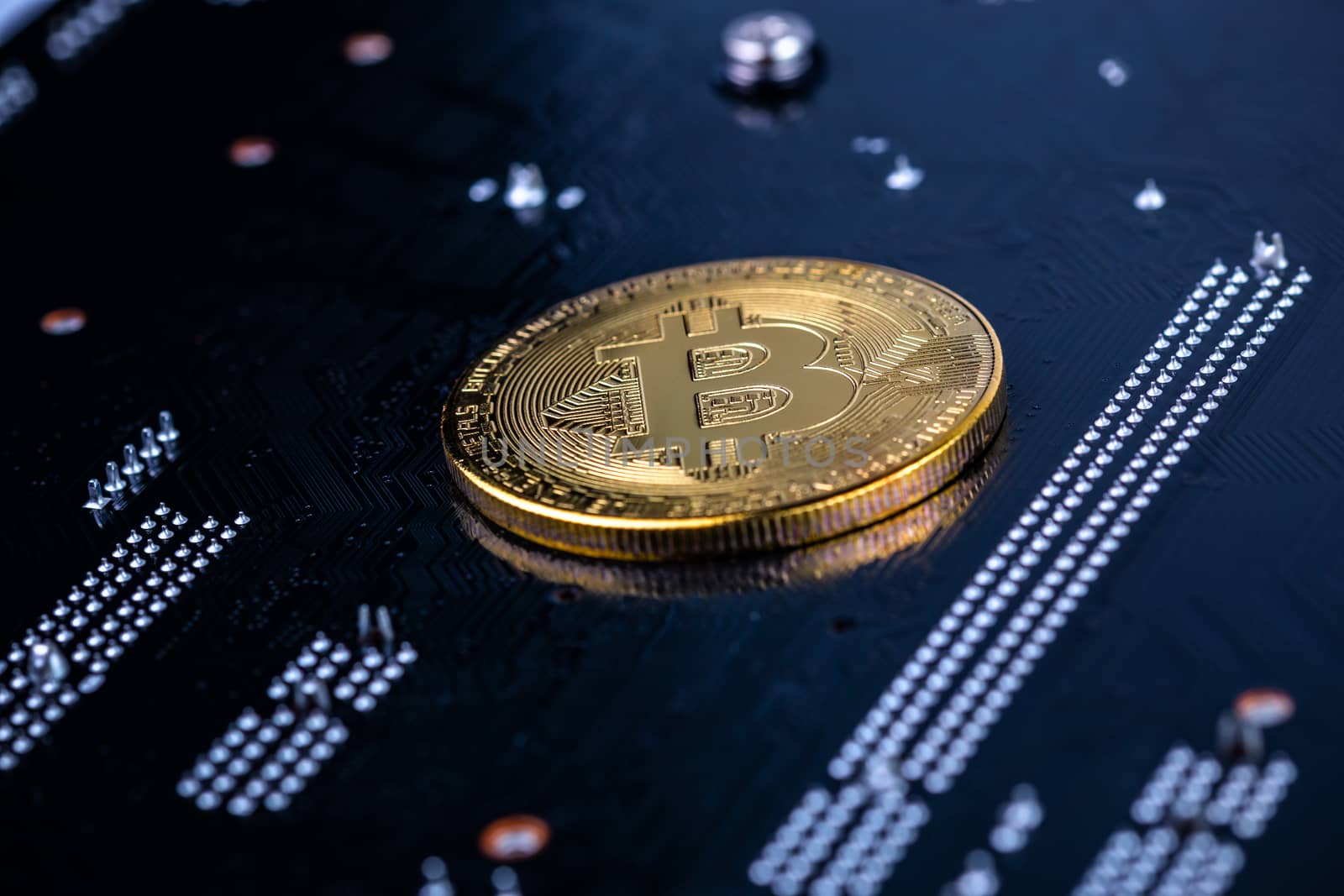 cryptocurrency background - bitcoin physical shiner ion black electronic board with selective focus and blur