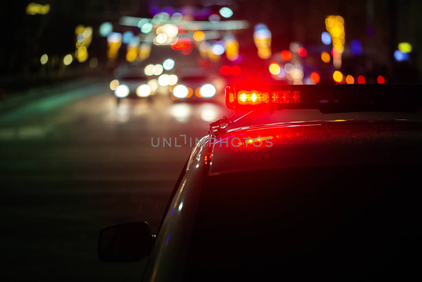 police car lights at night in city with selective focus and bokeh.