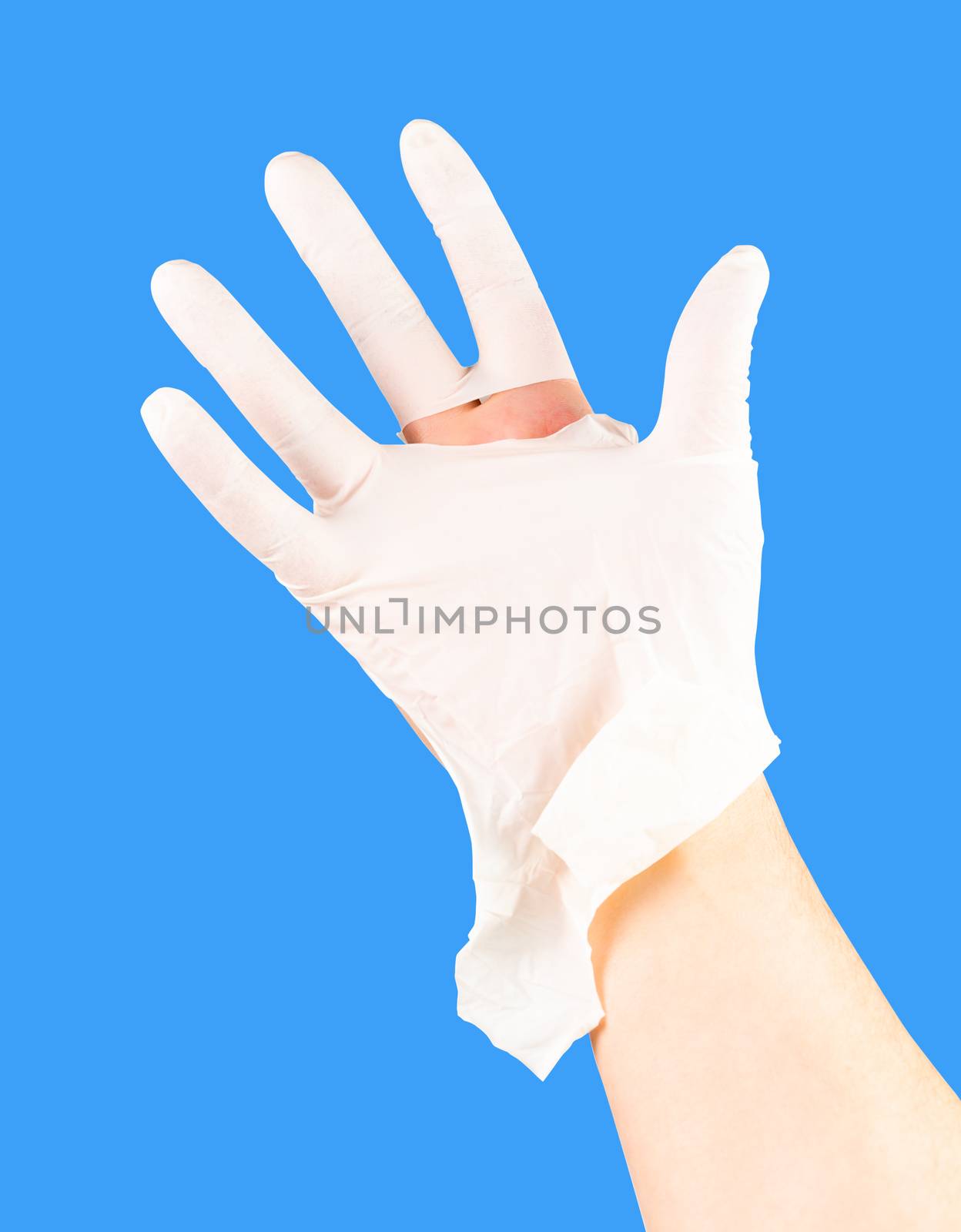 broken white latex surgeon medical glove on caucasian hand isolated on blue monocolor background.