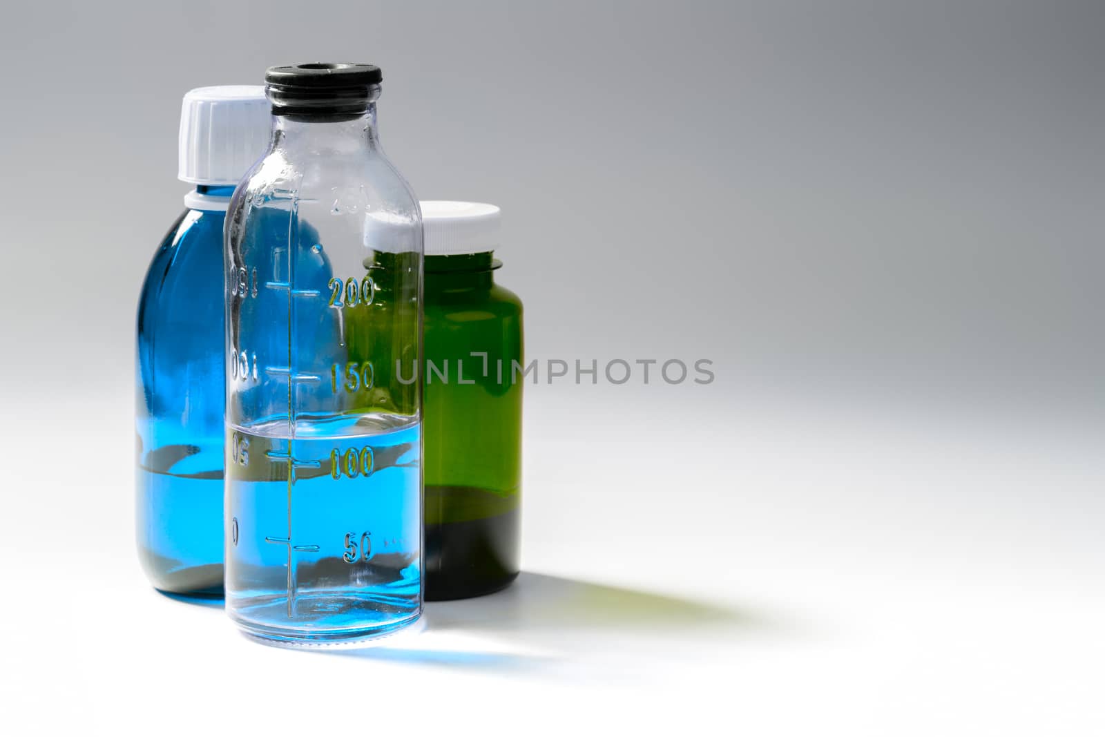 colored medial bottles on gray background with copyspace.