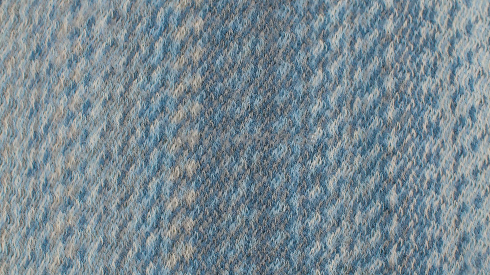 Extreme close up blue woolen fabric in woven pattern. Texture, textile background. Macro shooting