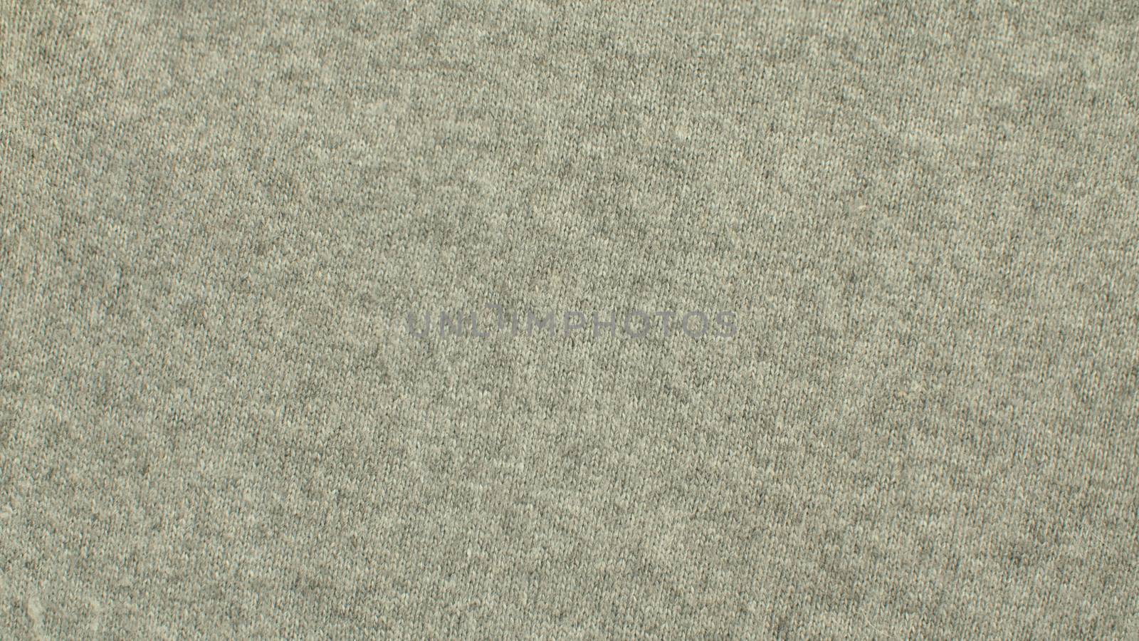 Extreme close up gray wool knitted fabric. Texture, textile background. Macro shooting