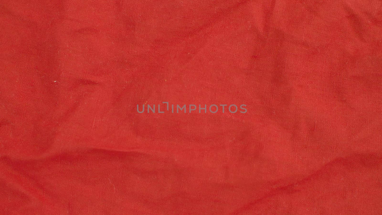 Extreme close up - red linen cloth. Texture, textile background. Macro shooting, camera slowly moving along the cloth on slider.