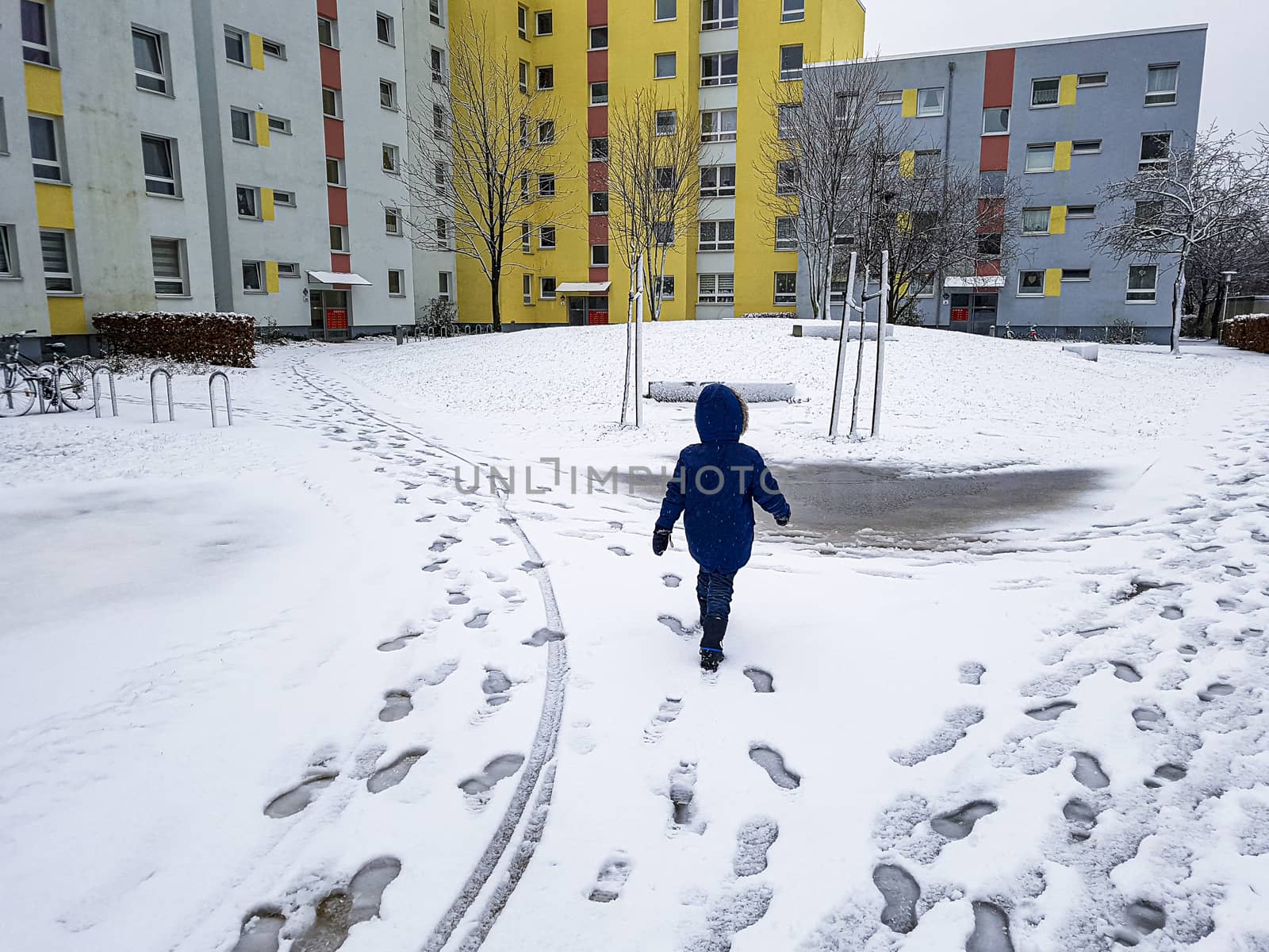 Child runs through the snow in Leherheide, Bremerhaven. by Arkadij