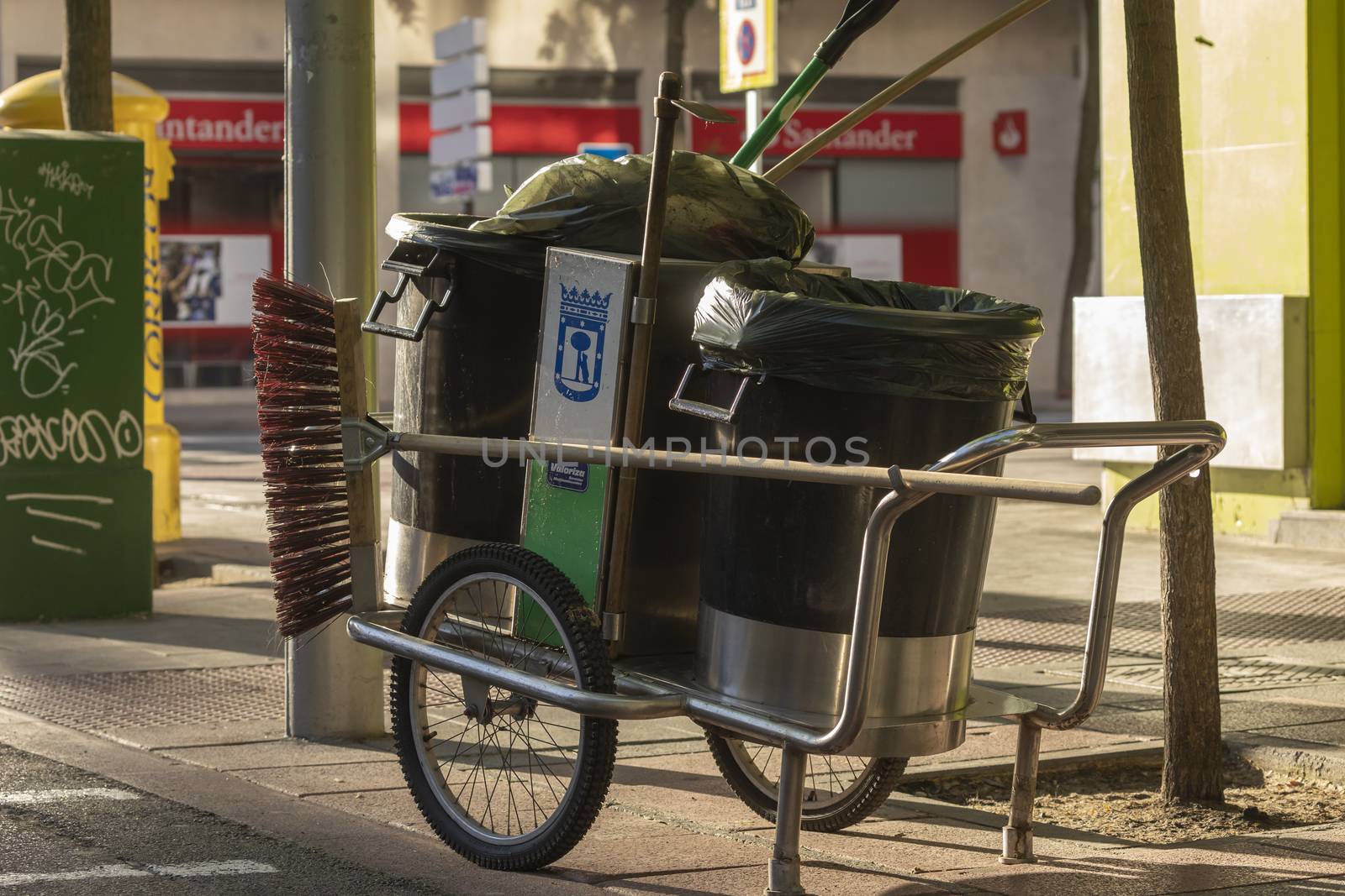 Madrid, Spain - May 19, 2020: Cleaning cart, garbage cans and the working utensils of a worker in her daily cleaning tasks, in the streets of Madrid.