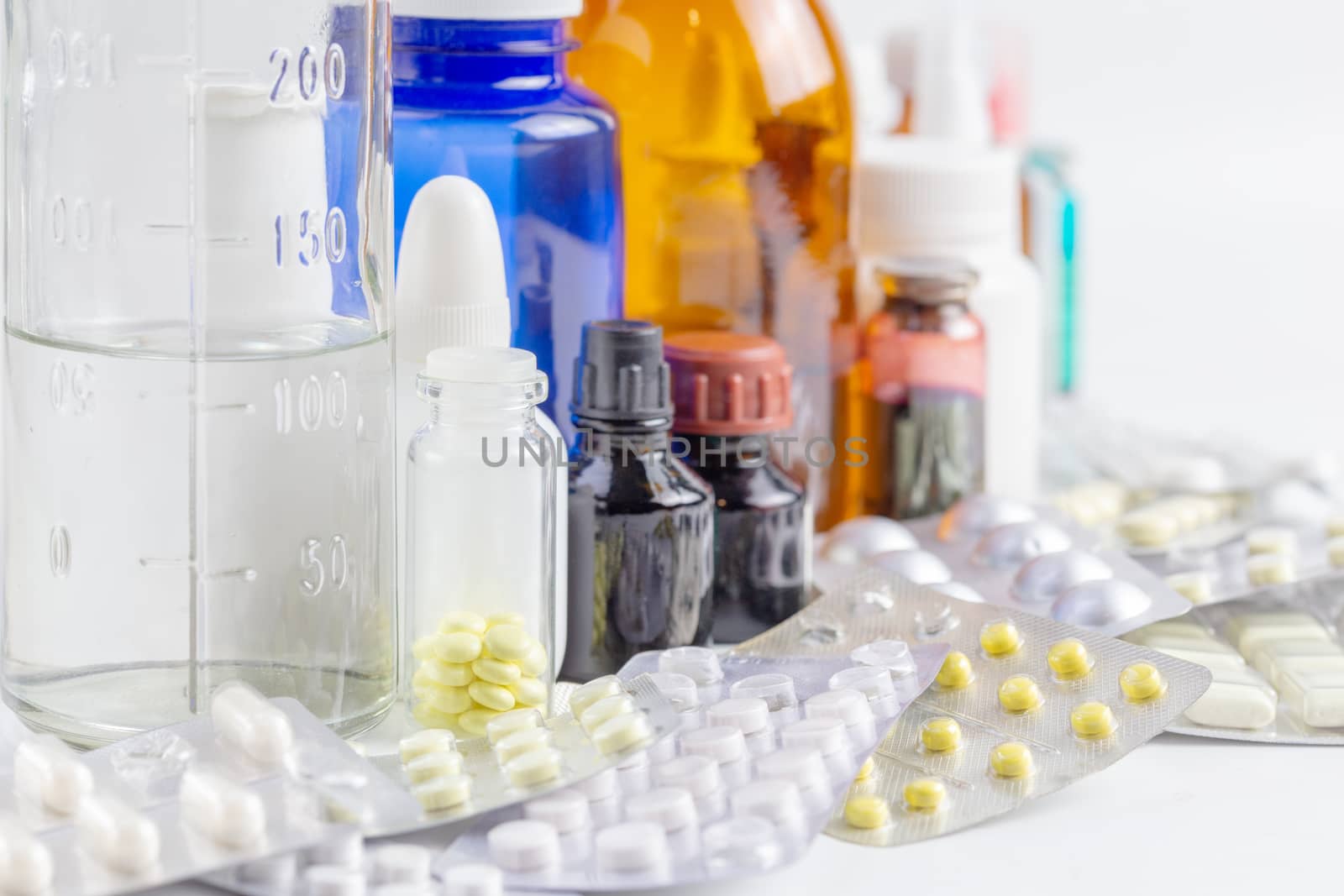 bunch casual of half-used and opened medial bottles and tablets with selective focus.