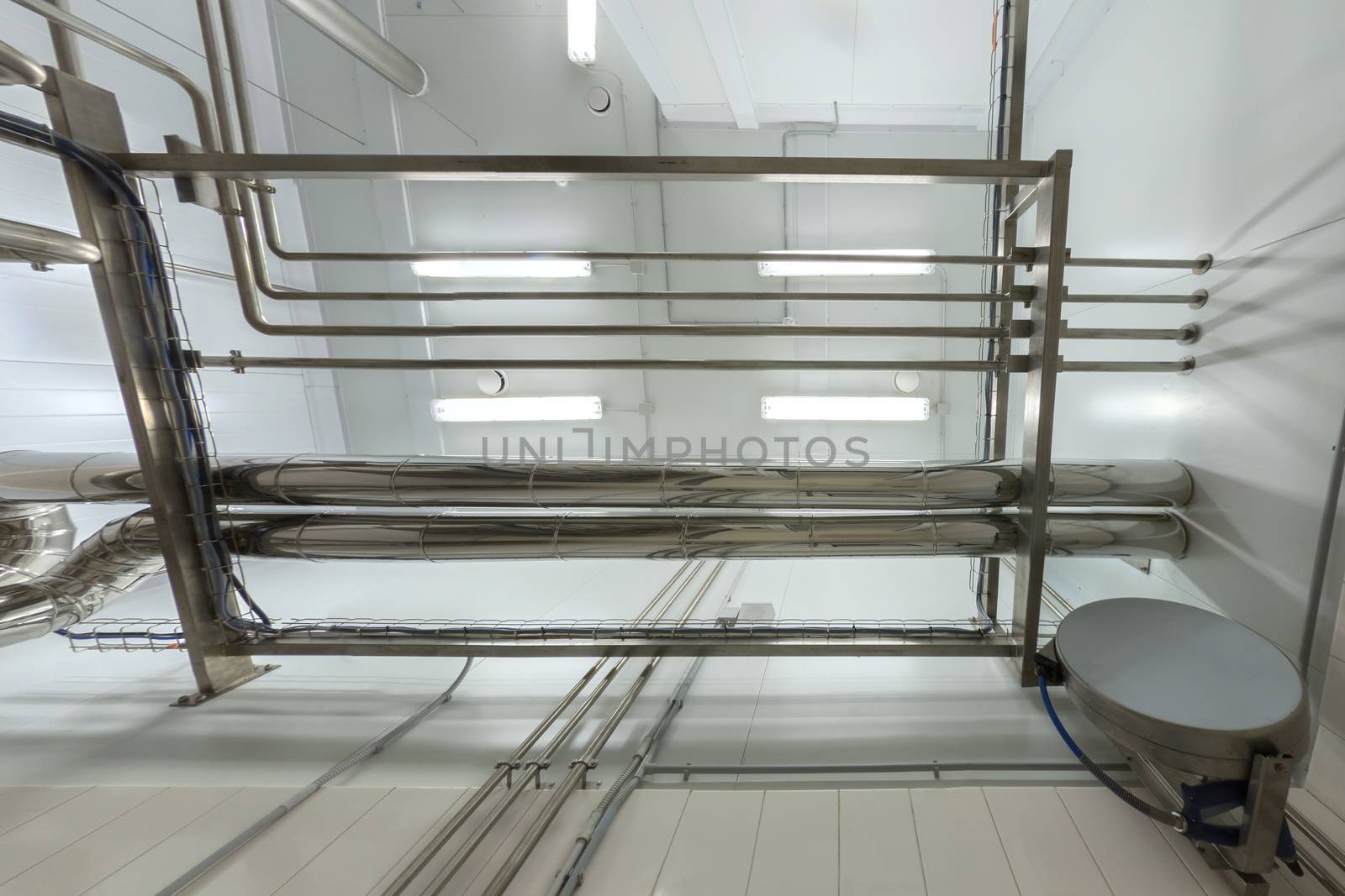 Industrial shiny steel pipeline overhead ceiling upward background. Chemical laboratory and science room style.