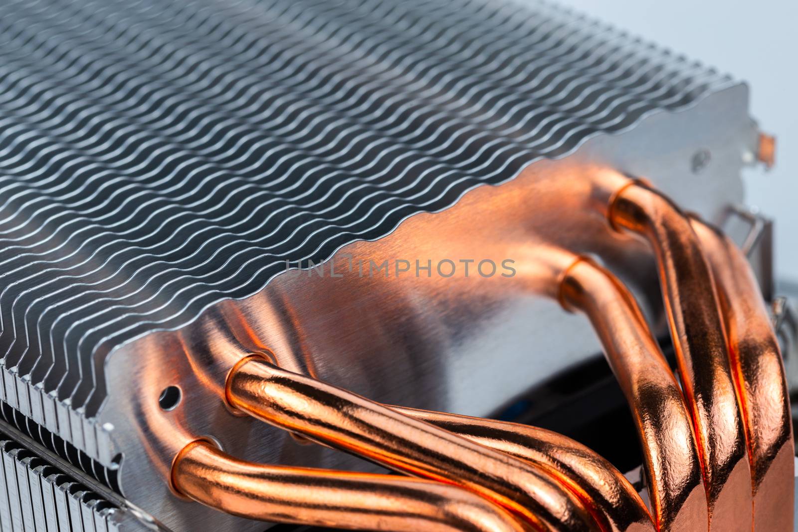 modern tower heat radiator with six copper heatpipes closeup macro background with selective focus, blur and diagonal composition