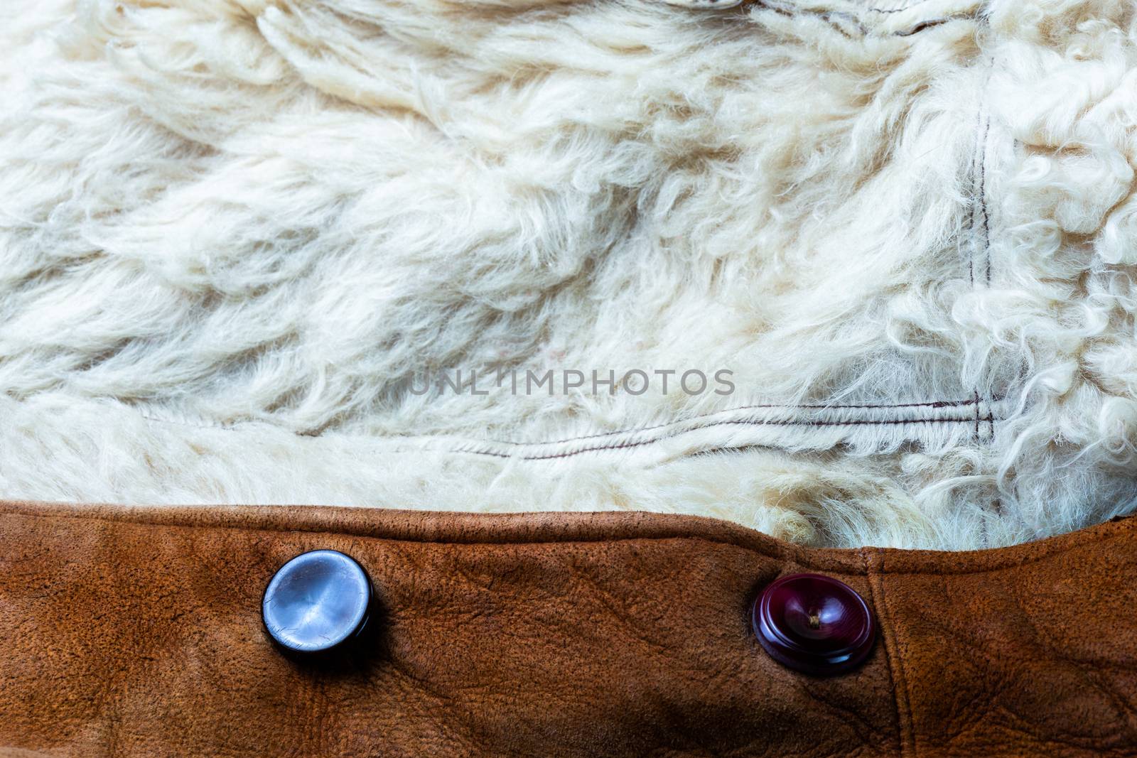 small brown thick seude jacket with white sheep fur lining closeup texture and background with selective focus and blur