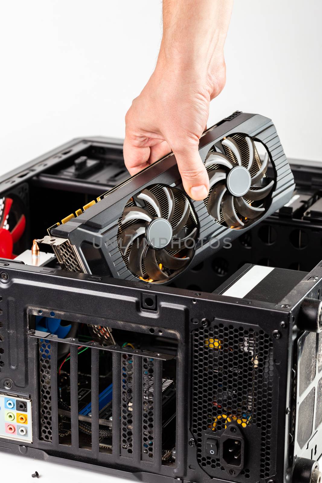 hand plugging a video card while maintenance personal computer hardware with selective focus closeup