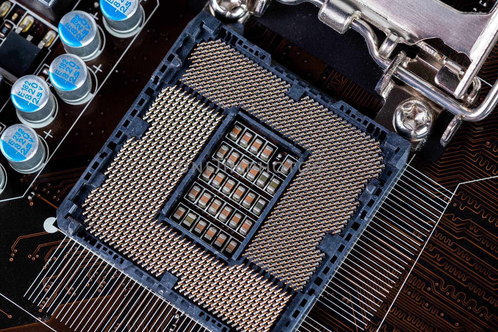 opened central processor land grid array slot on pc mainboard - closeup shot with selective focus and blur