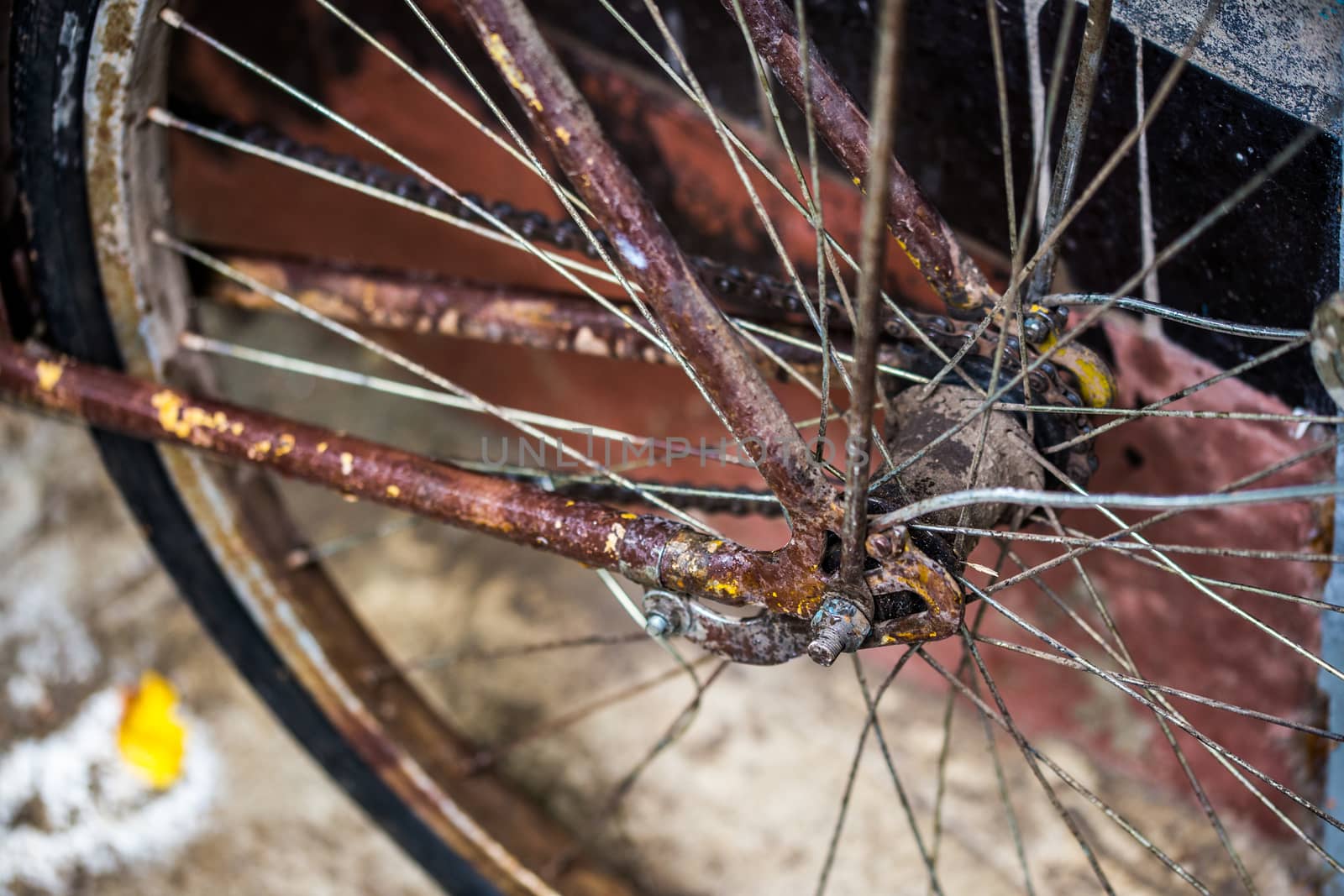 old wet rused brown bicycle after rain closeup with selective focus and blur.