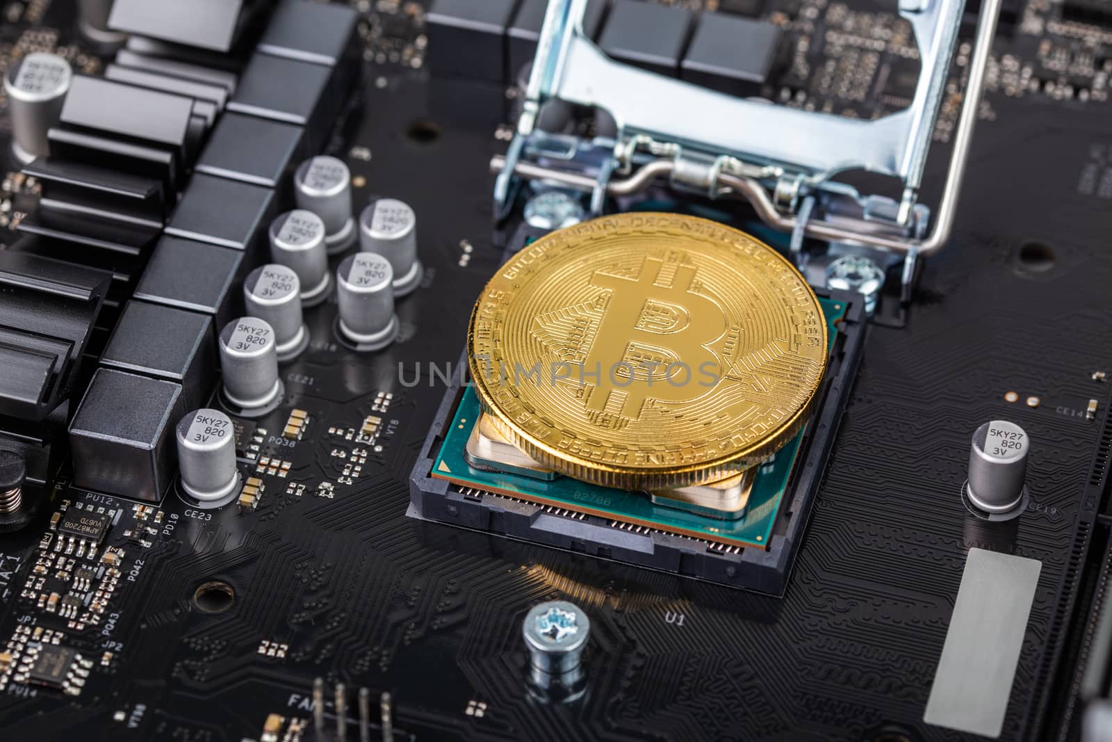 cryptocurrency background - bitcoin physical shiner in cpu socket of modern cpu motherboard with selective focu and blur