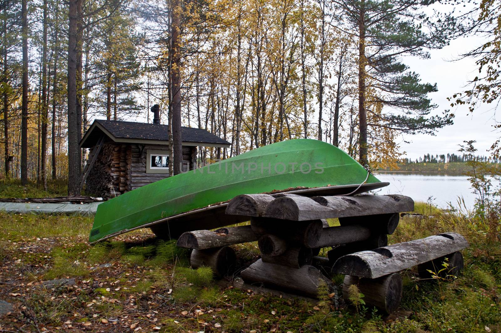 A cabin and boat at a lake in the region of Kainuu, Finland