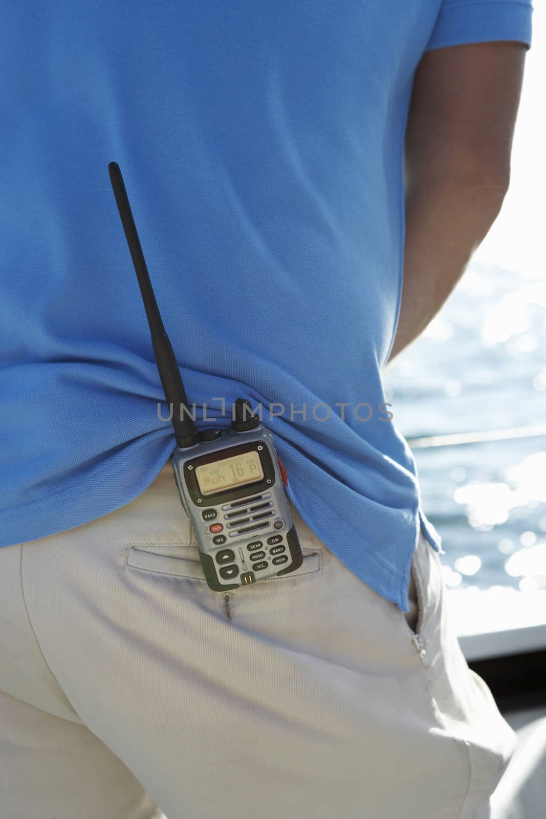 Communication device on man's waist mid section by moodboard