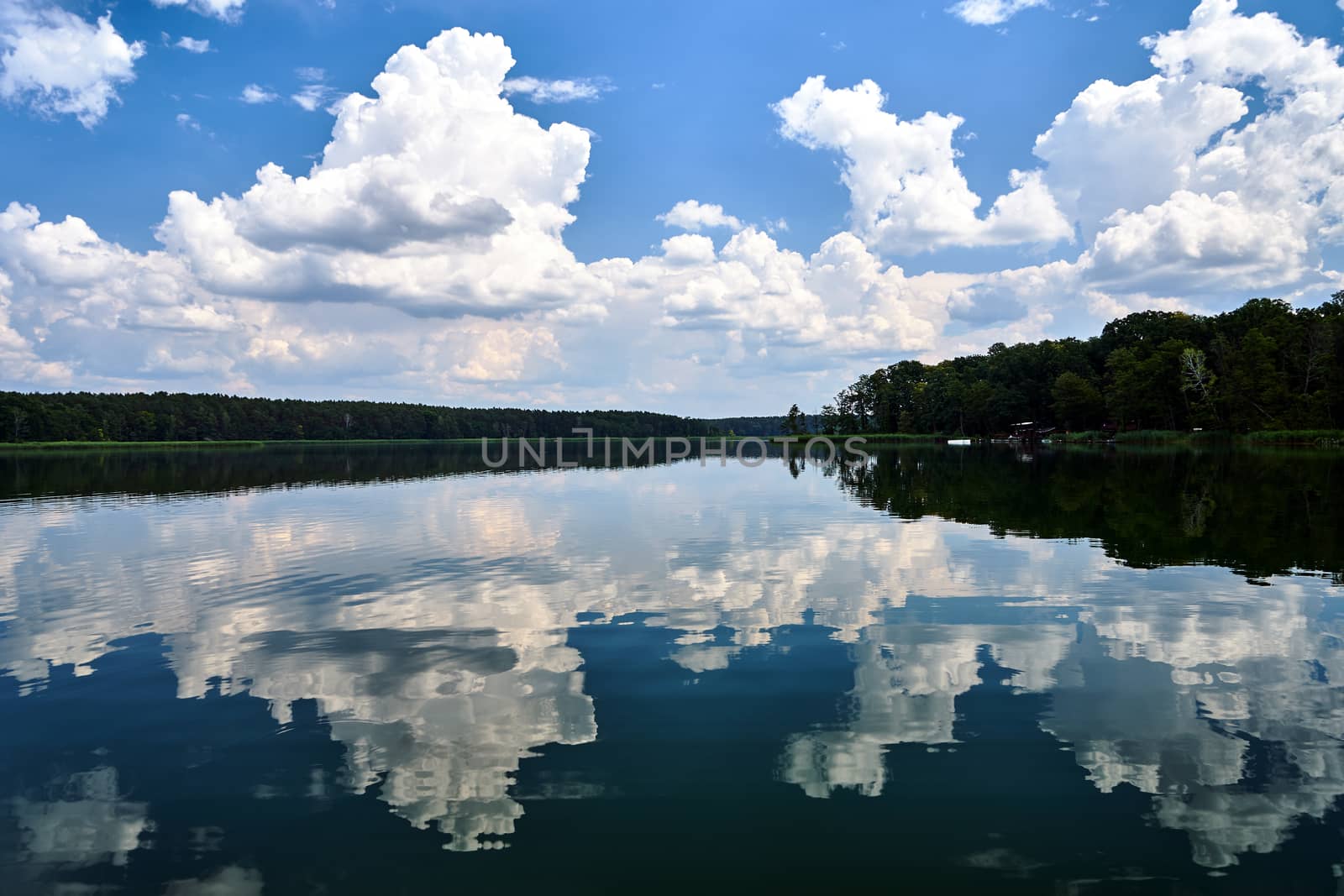 reflection of clouds in the waters of Lake Chycina during summer in Poland