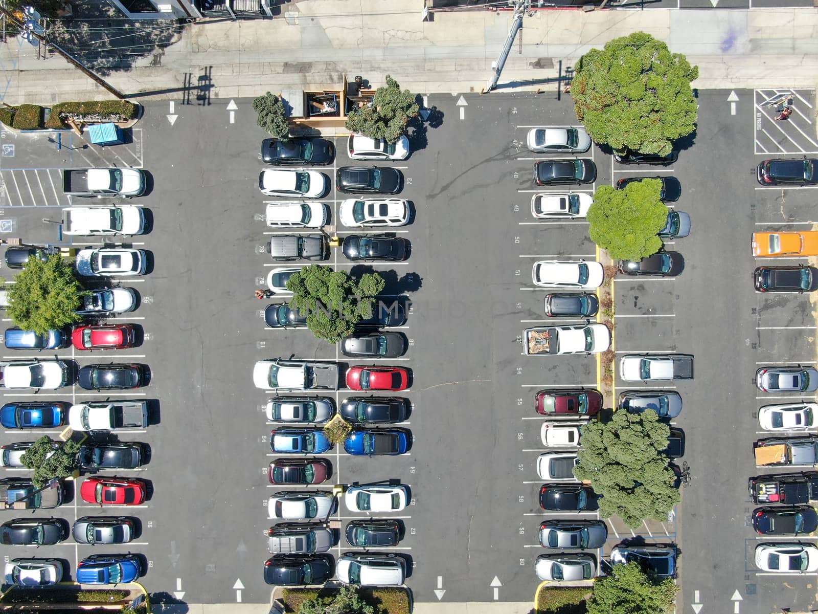 Aerial top view of parking lot with varieties of colored vehicles. Pacific Beach. California