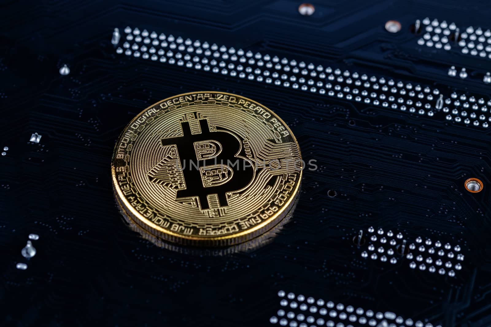 cryptocurrency background - bitcoin physical shiner ion black electronic board with selective focus and blur