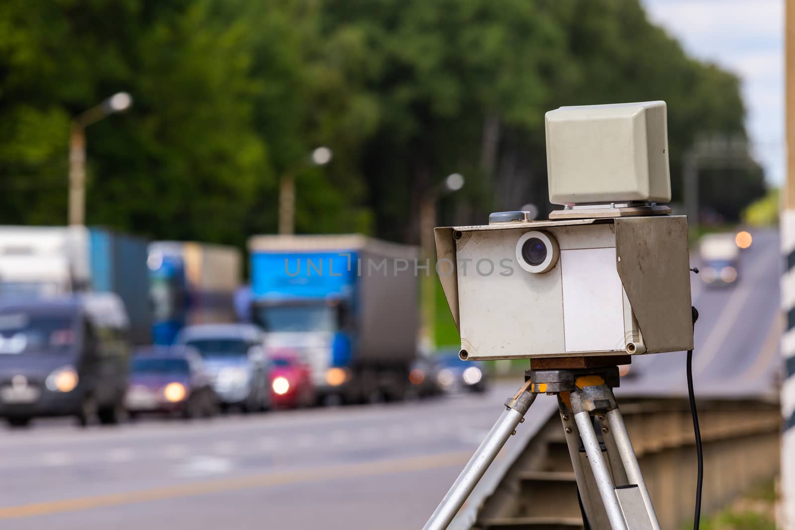 mobile speed camera device working on summer daytime road with selective focus