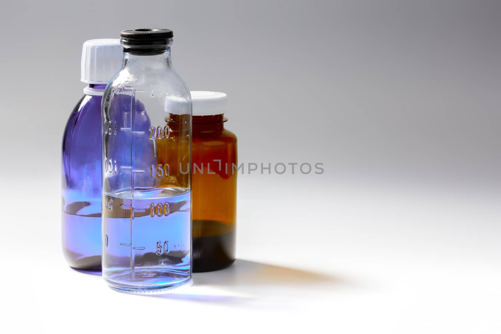 colored medial bottles on gray background with copyspace.