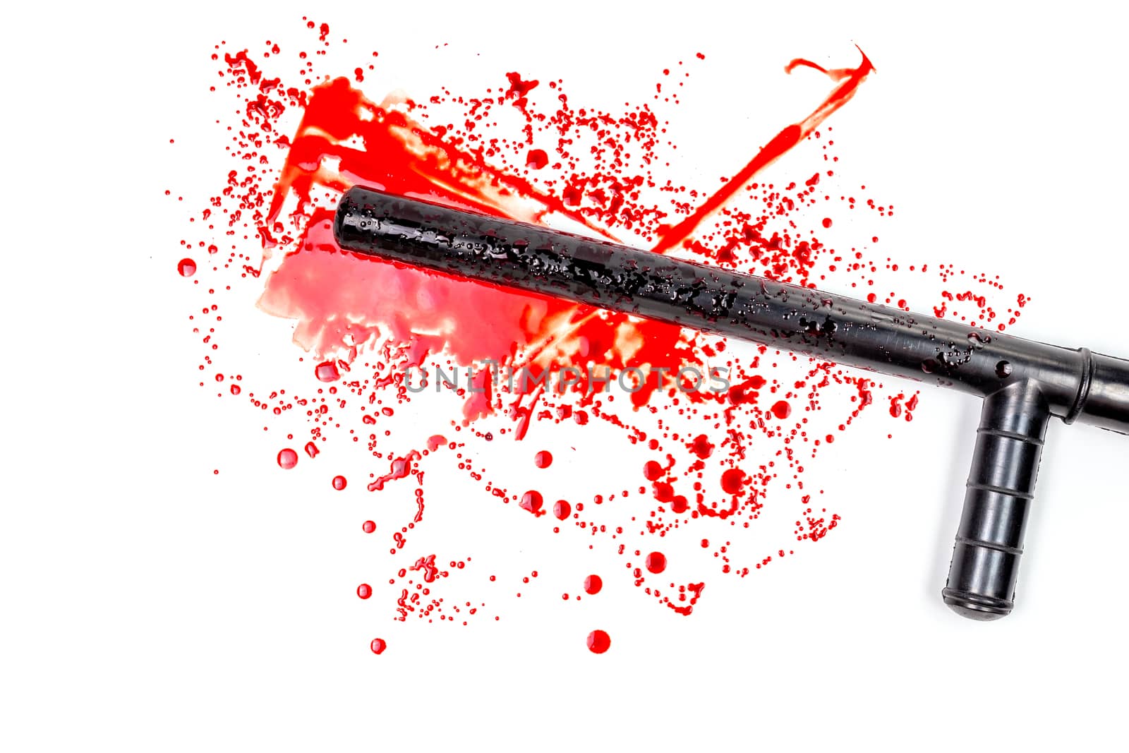 Bloody russian police rubber tonfa baton in blood spatter isolated on white background in top-down flat lay perspective. Natural human blood used.