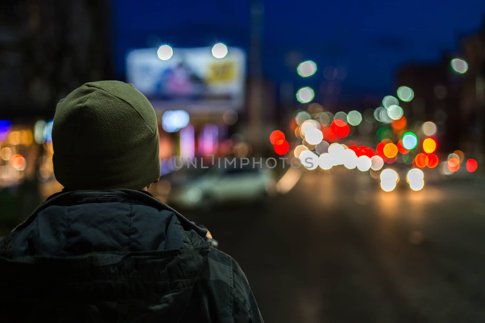 stranger man back in night city with boke background at cold season
