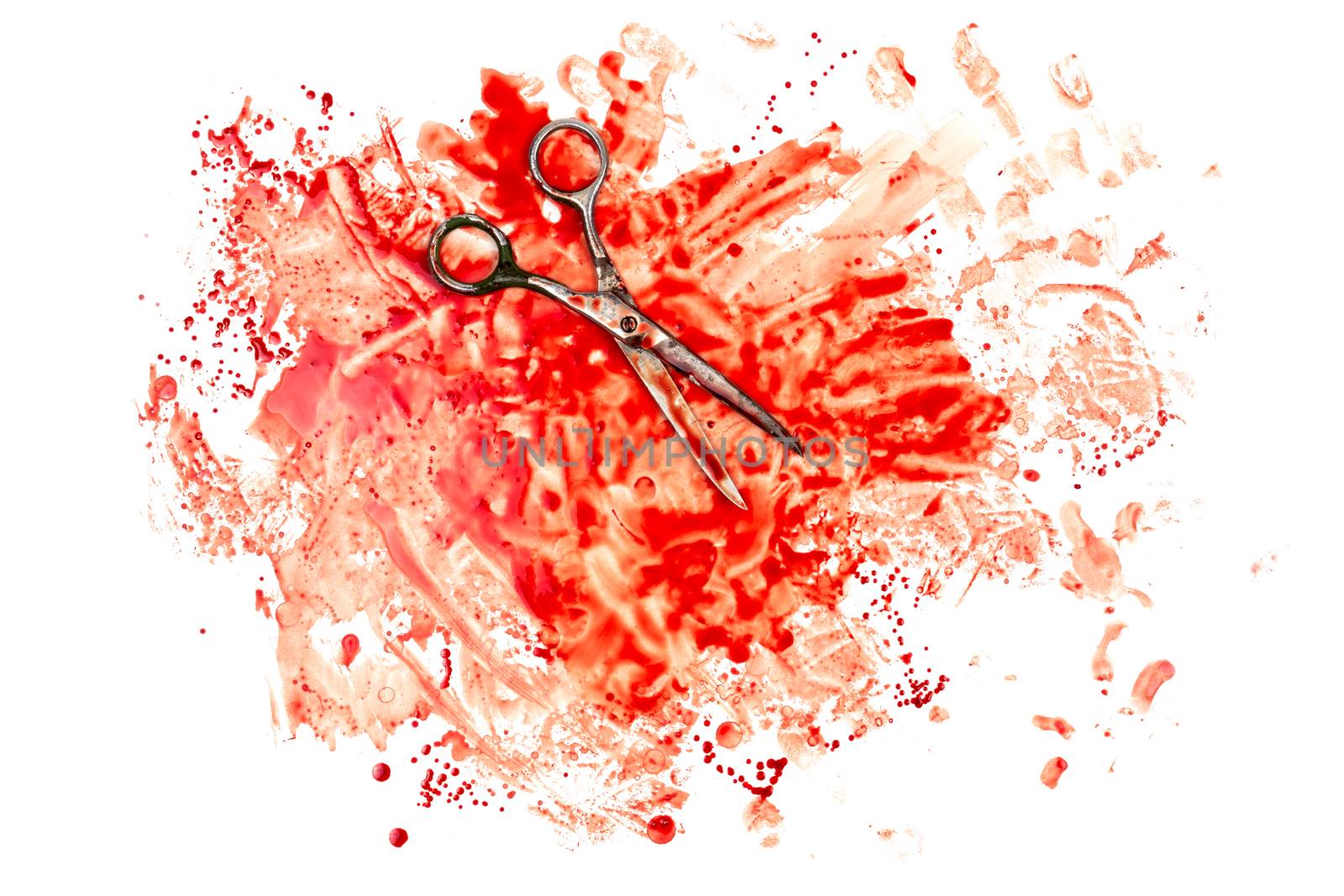 old soviet scissors on human blood splatter isolated on white background in flat lay top-down perspective.