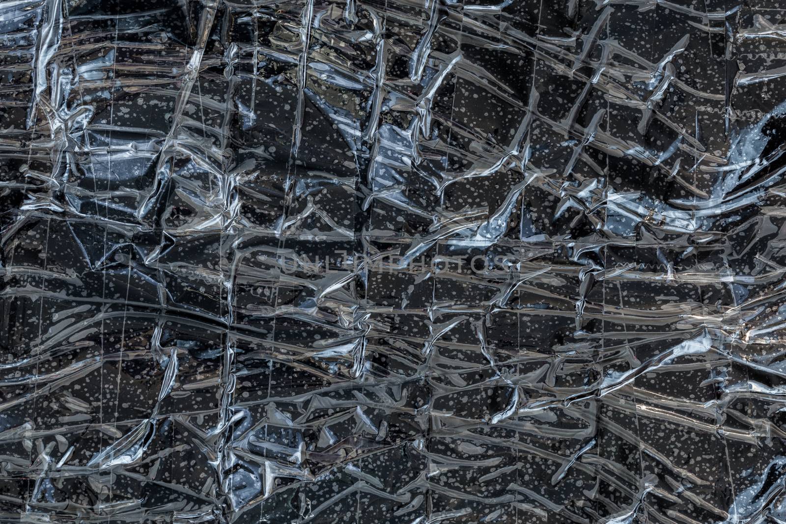 black polyethilene film enforced by sticky tape flat smuggle package texture and background