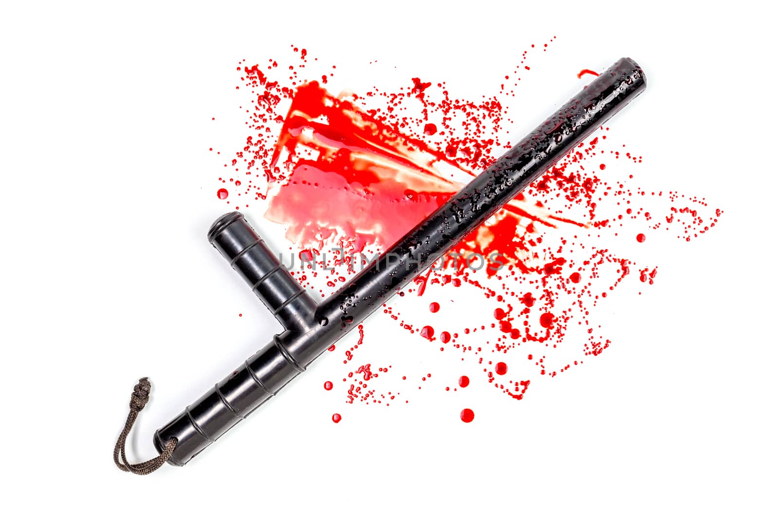 Bloody russian police rubber tonfa baton in blood spatter isolated on white background in top-down flat lay perspective. Natural human blood used.