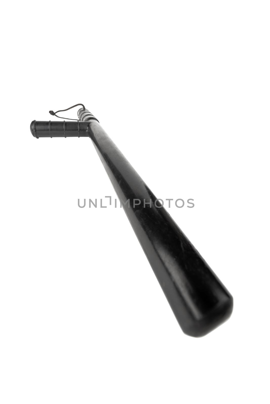 Black classic rubber police tonfa baton isolated on white background with selective focus and wide angle perspective.