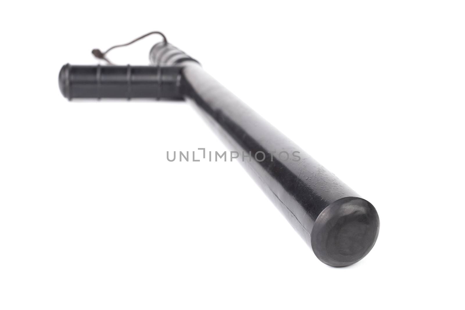 Black classic rubber police tonfa baton isolated on white background with selective focus and wide angle perspective.
