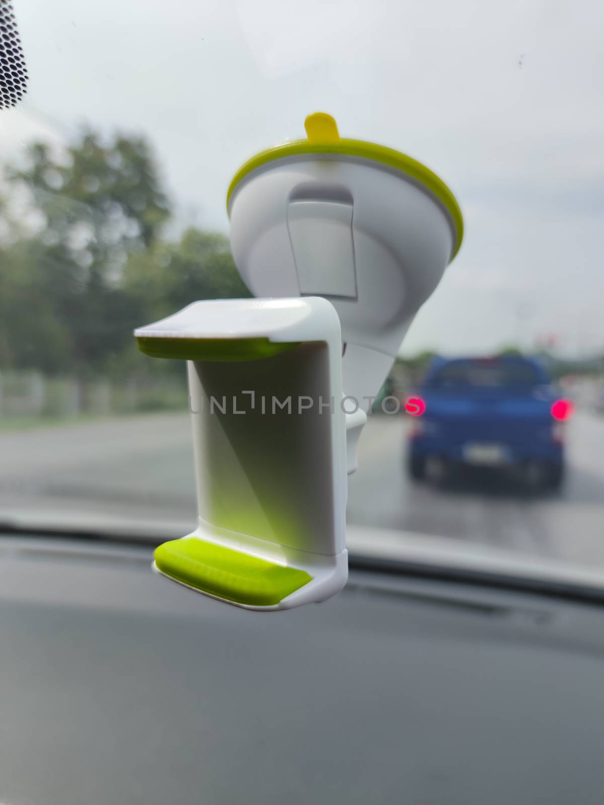 white green blank smartphone holder stuck in the windscreen of a by tidarattj