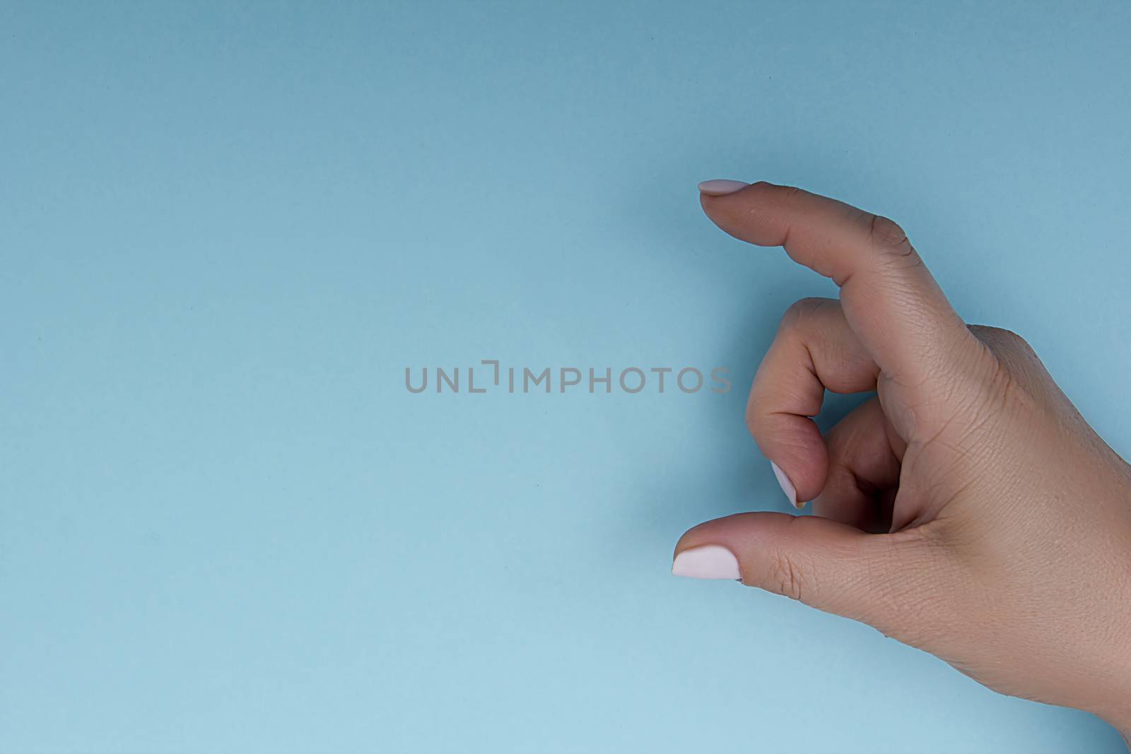 Female hand measuring something by VIPDesignUSA