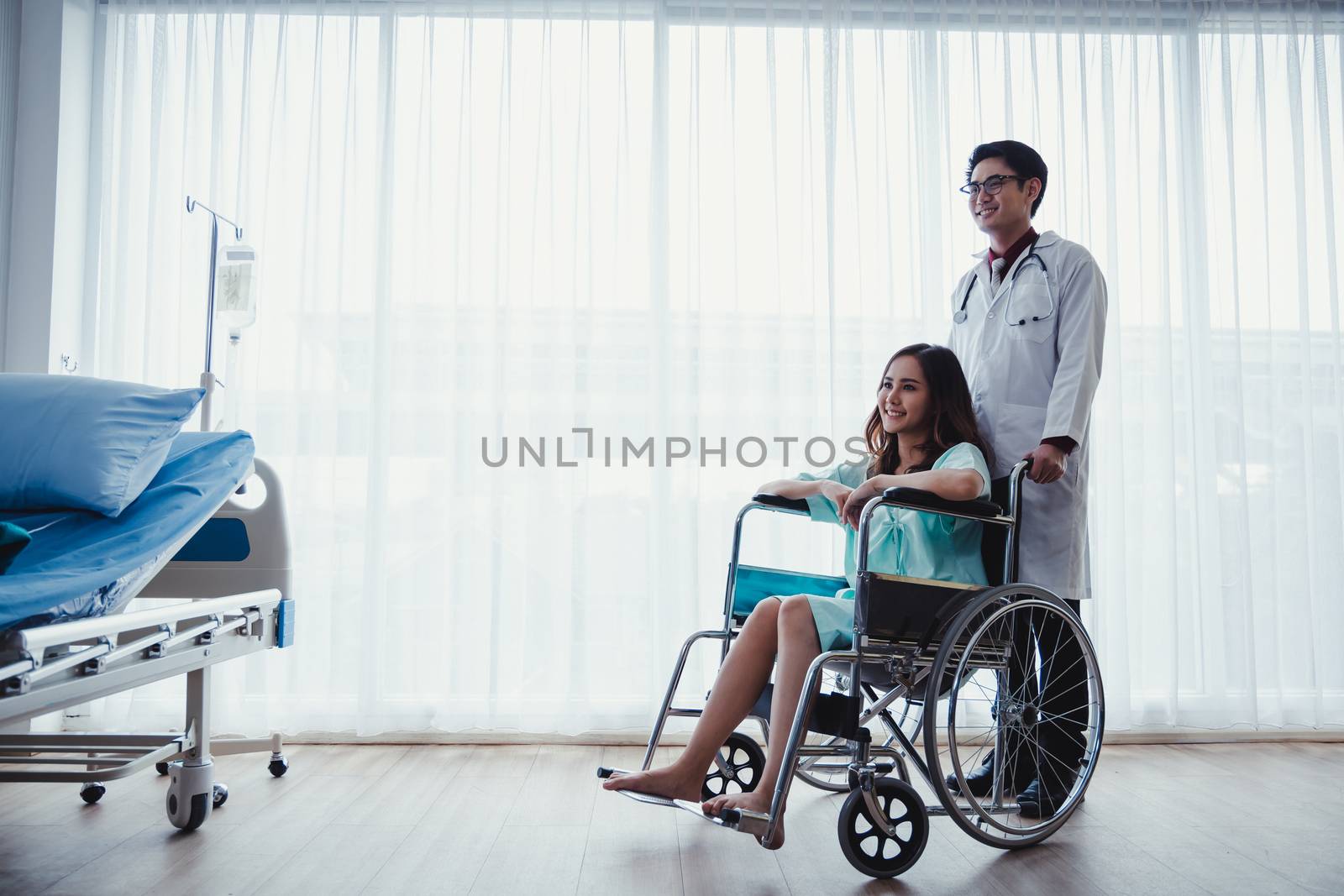 Doctor and the female patient are smiling because her symptoms are improving in the hospital.