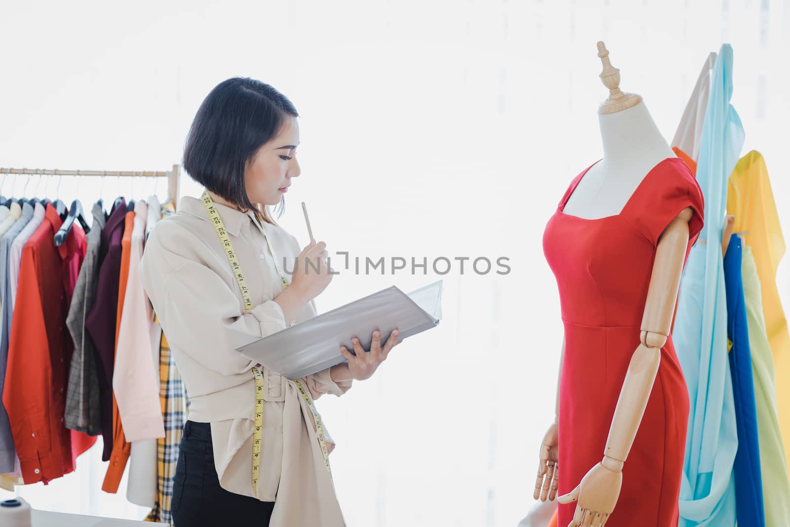Professional fashion designers are checking new clothes that have been cut and delivered to customers.