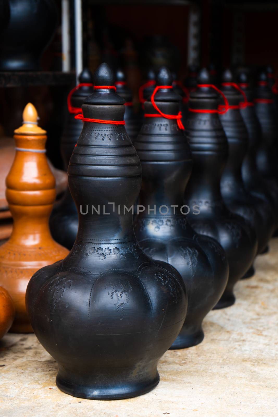 Showcase with clay pots from handmade jugs. Asian traditional jugs