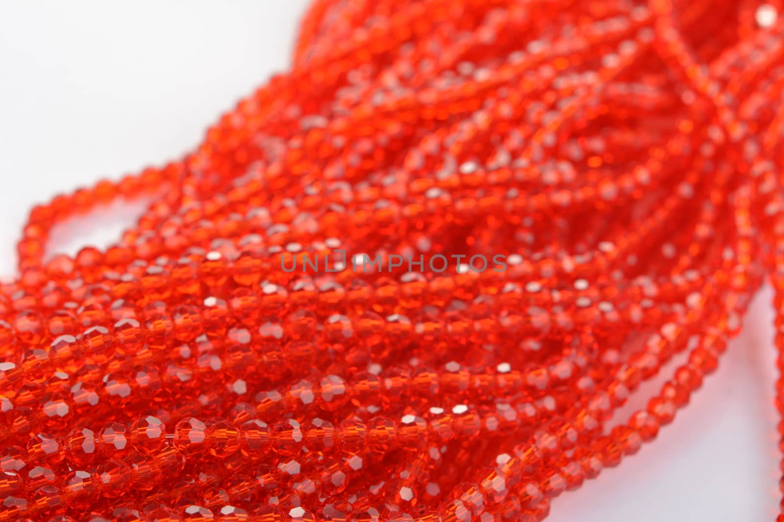 Beautiful Red scarlet, ruby Glass Sparkle Crystal Isoalted Beads on white background. Use for diy beaded jewelry. Space for text