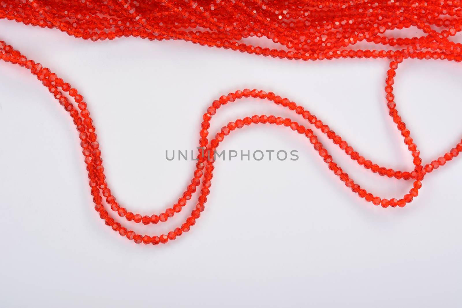 Beautiful Red scarlet, ruby Glass Sparkle Crystal Isoalted Beads on white background. Use for diy beaded jewelry. Space for text