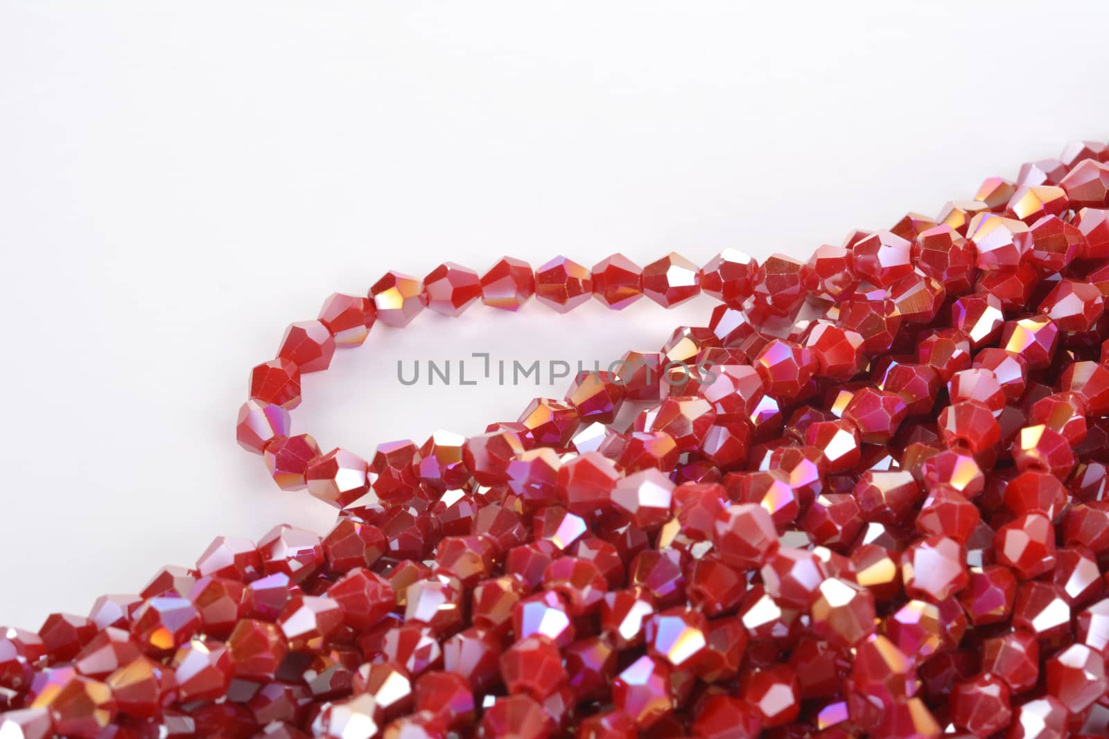 Beautiful Red scarlet, ruby Glass Sparkle Crystal Isoalted Beads on white background. Use for diy beaded jewelry. Space for text